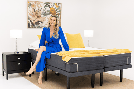 lady sitting on Dual King Sophie Adjustable Bed