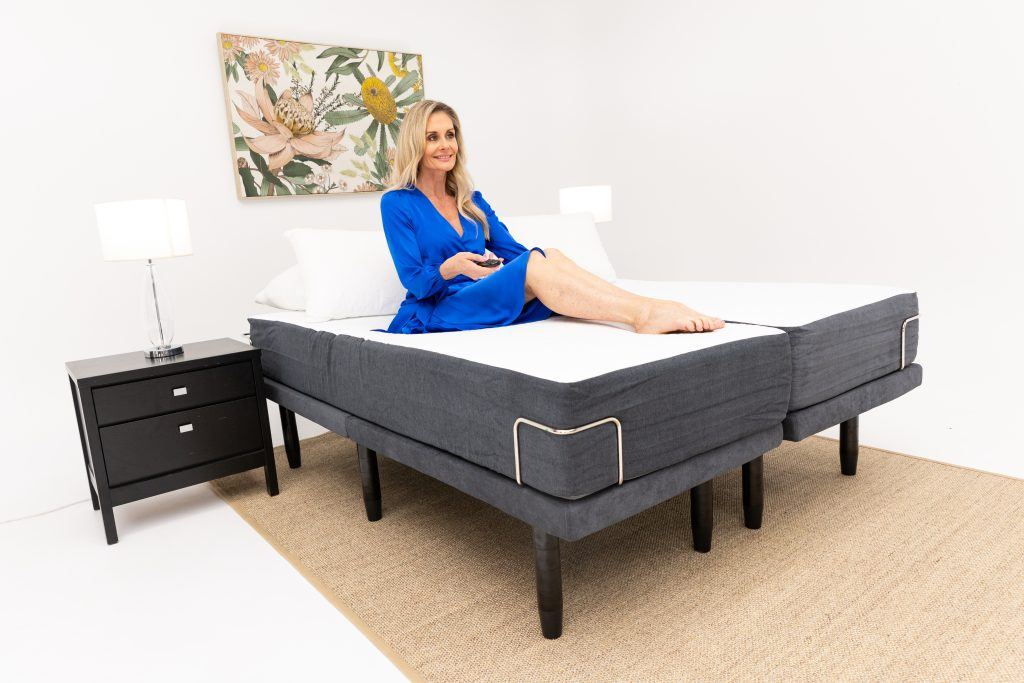 Side sleeper on an adjustable bed, showing the head and foot sections raised at gentle ang